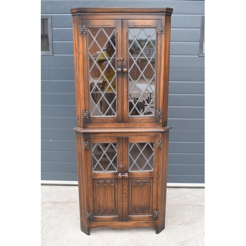 330 - A wooden 20th century Priory style corner display cabinet with glazed upper half. 172cm tall. In goo... 