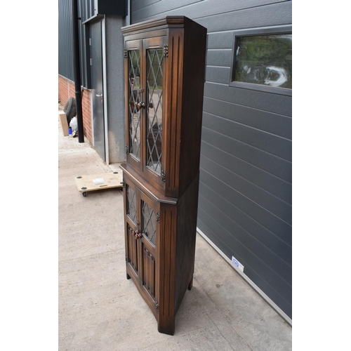 330 - A wooden 20th century Priory style corner display cabinet with glazed upper half. 172cm tall. In goo... 