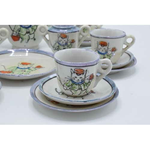 43 - A 20th century dolls tea set decorated with cats to consist of 6 trios, milk jug, teapot, lidded sug... 