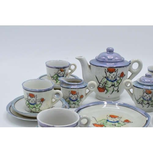 43 - A 20th century dolls tea set decorated with cats to consist of 6 trios, milk jug, teapot, lidded sug... 