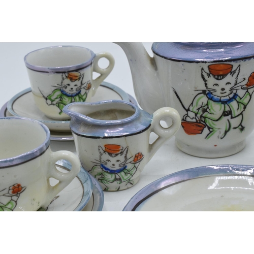 43 - A 20th century dolls tea set decorated with cats to consist of 6 trios, milk jug, teapot, lidded sug... 