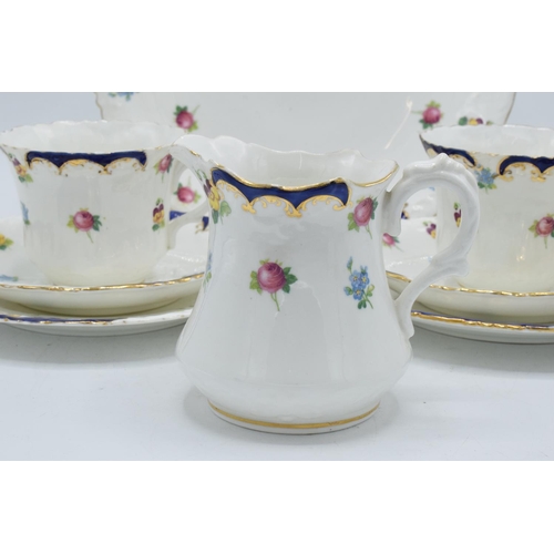 47 - The Paragon China blue floral tea set circa 1912 to consist of 8 trios, 4 further side plates, a cak... 