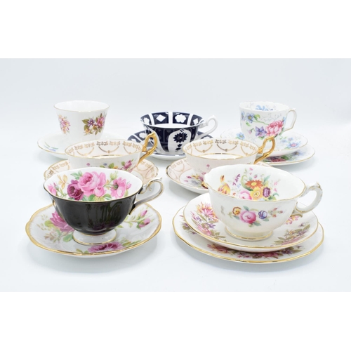 49 - A collection of china cups and saucers to include duos and trios by makers such as Royal Albert, Reg... 