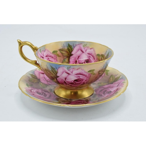 74 - Aynsley Bone China cup and saucer duo in a pink floral design (2). In good condition with no obvious... 