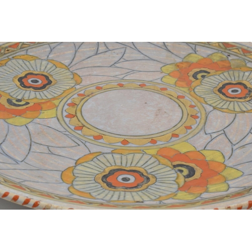 79 - Crown Ducal Charlotte Rhead 1930s tubelined charger in a stylised floral design 32.5cm diameter. In ... 