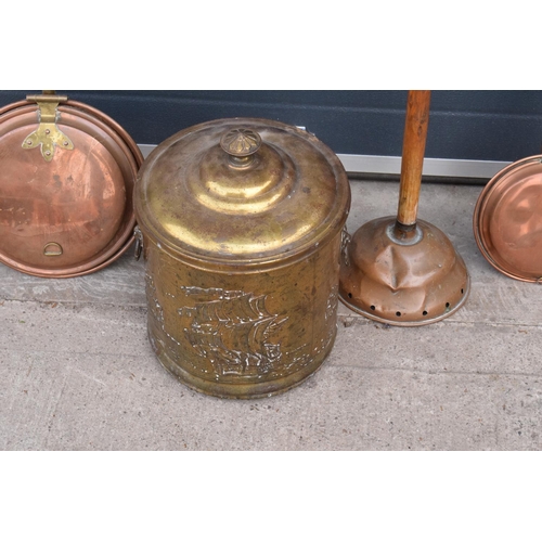 275A - A collection of metal ware to include a brass coal bucket, 2 copper bed pans and a similar item (4).