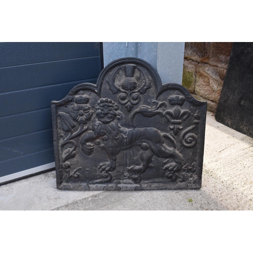 374 - An 18th century style cast iron fireback depicting a lion passant, a fleur de lys and a Scottish thi... 