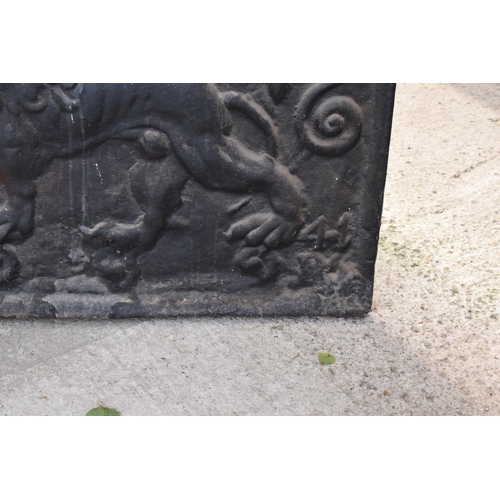 374 - An 18th century style cast iron fireback depicting a lion passant, a fleur de lys and a Scottish thi... 