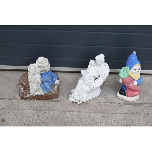 301J - A collection of vintage garden ornaments to include a garden gnome, a figure of a couple and one sim... 