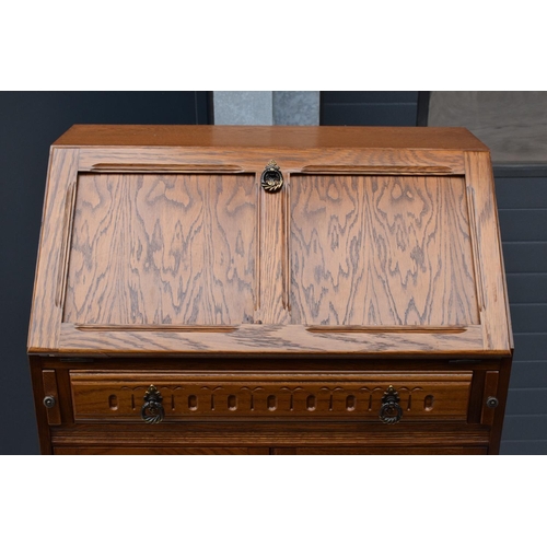 387 - A 20th century wooden bureau in the Old Charm style. 77 x 45 x 100cm.