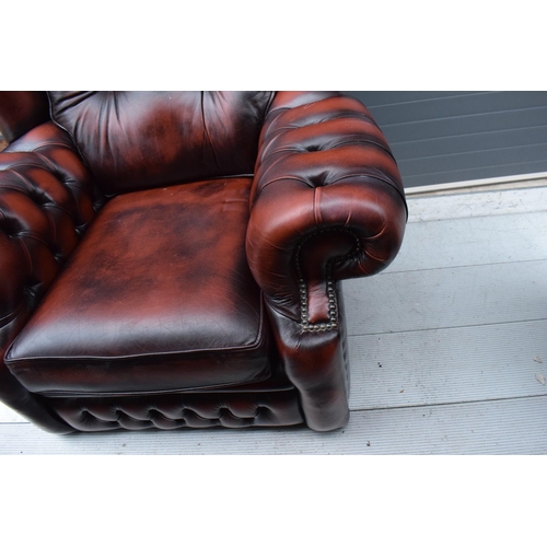 388 - A modern Chesterfield style wingback armchair with button back design raised on 4 wooden feet in oxb... 