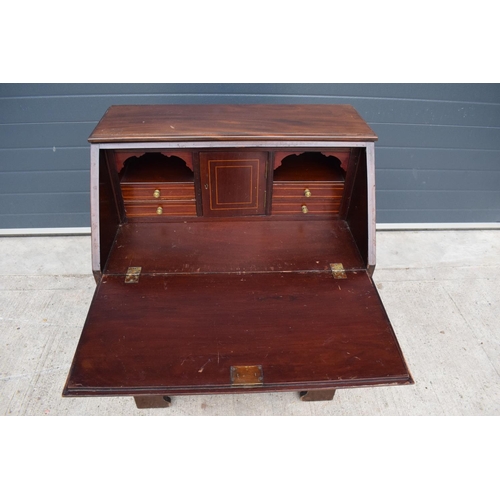 390 - A 19th century inlaid mahogany bureau with the fall front revealing a fitted interior inlaid with a ... 