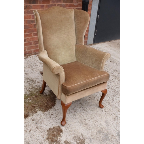 392 - A late 20th century Parker Knoll wingback armchair. 104cm tall.