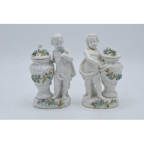 95D - A pair of Meissen Continental figures depicting cherubs with floral urns with 'JR' monogram to base ... 