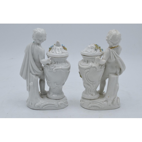 95D - A pair of Meissen Continental figures depicting cherubs with floral urns with 'JR' monogram to base ... 