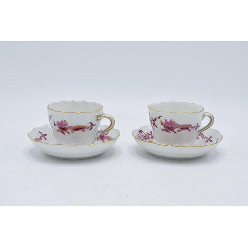 95H - A pair of early 20th century Meissen demitasse cups and saucers decorated with a purple dragon desig... 