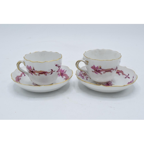 95H - A pair of early 20th century Meissen demitasse cups and saucers decorated with a purple dragon desig... 