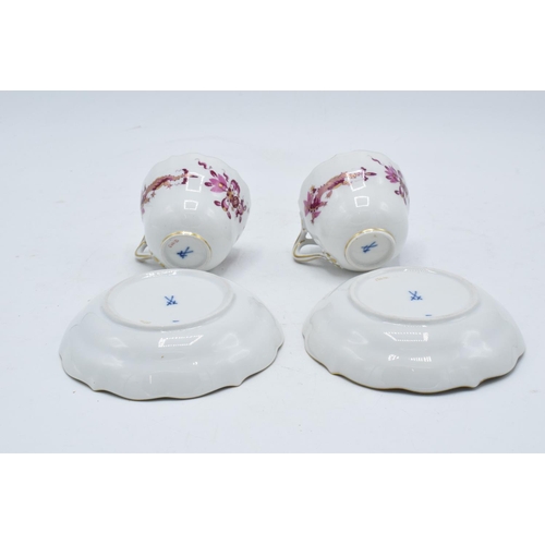 95H - A pair of early 20th century Meissen demitasse cups and saucers decorated with a purple dragon desig... 