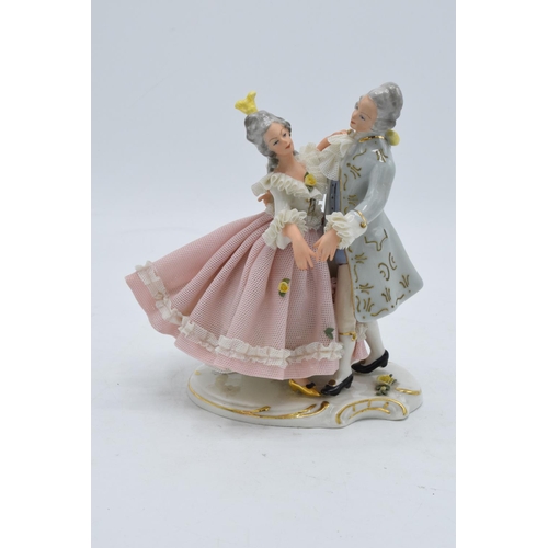 95K - A late 19th / early 20th century Dresden lace figure of a couple dancing with the 'N' mark below a 5... 