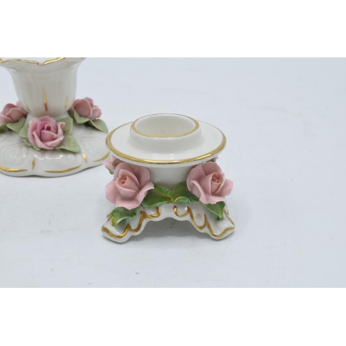 95L - A collection of early 20th century pottery candlesticks with raised floral decoration to include a D... 