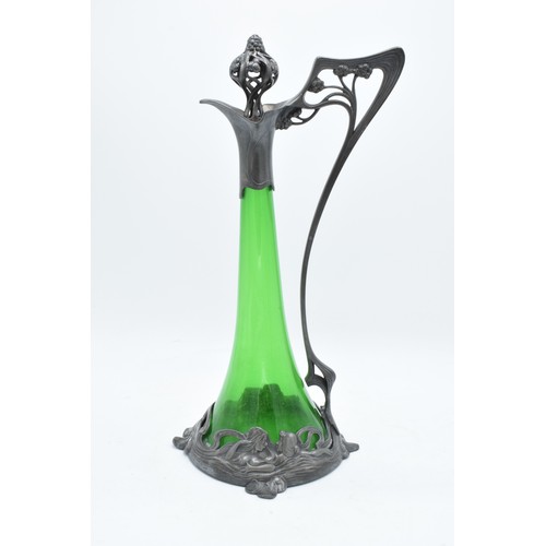 A WMF art nouveau pewter claret jug with threaded stopper, tapering green glass body and designed maidens around the base. Stamped to base, WMF, EP. 37cm tall. In good condition with no obvious damage or restoration though missing 2 small metal supports on the underside.