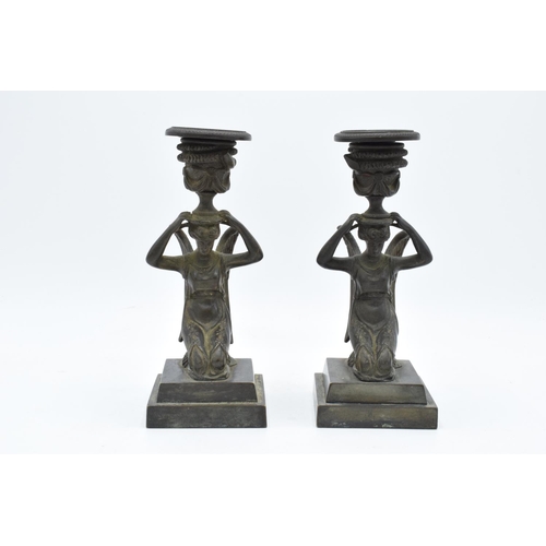 A pair of 19th century Grand Tour Bronze candlesticks depicting ladies with wings holding an urn on their head, circa 1830s. In good condition with no obvious damage or restoration. The candle holder is detachable on both. 18.5cm tall.