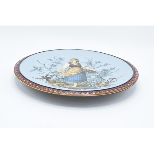 65 - Late 19th century Mettlach (Villeroy and Boch) wall charger after C. Warth decorated with a lady hol... 