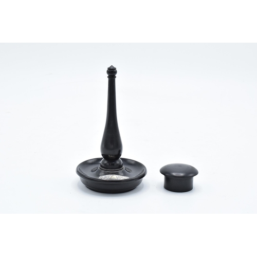 307 - An ebony ring stand with a silver mount (London) together with an ebony circular pill box (2). 11cm ... 