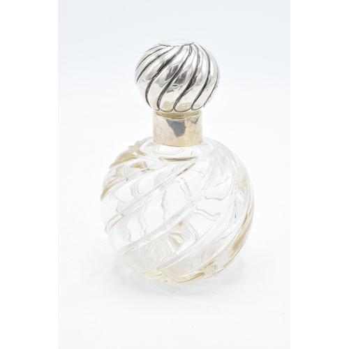 309 - Silver topped scent bottle with swirling glass decoration 13cm tall. Hallmarked for London, hallmark... 