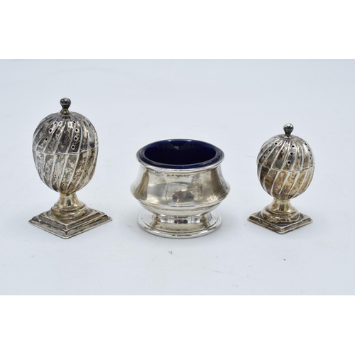 320 - A collection of hallmarked silver items to include acorn shaped cruet shakers (42.3 grams of silver)... 