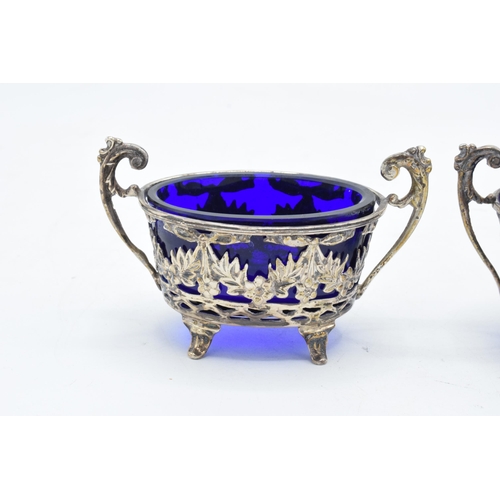 321 - A pair of silver table salts with associated blue glass liners (2). Chester 1894. 101.3 grams of sil... 