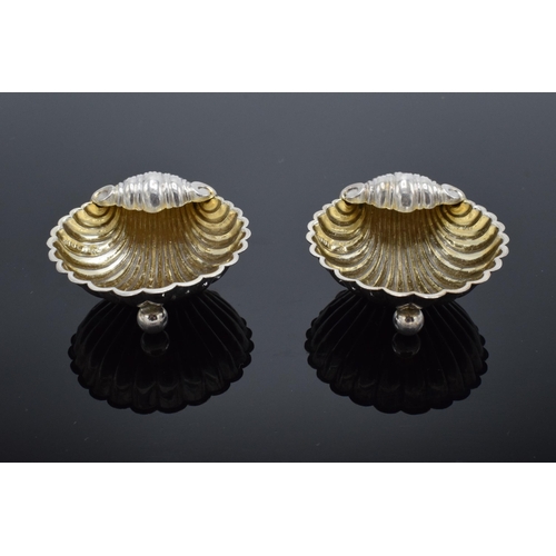 323 - A pair of silver table salts in the form of shells raised on ball feet. Hallmarked for Birmingham ci... 