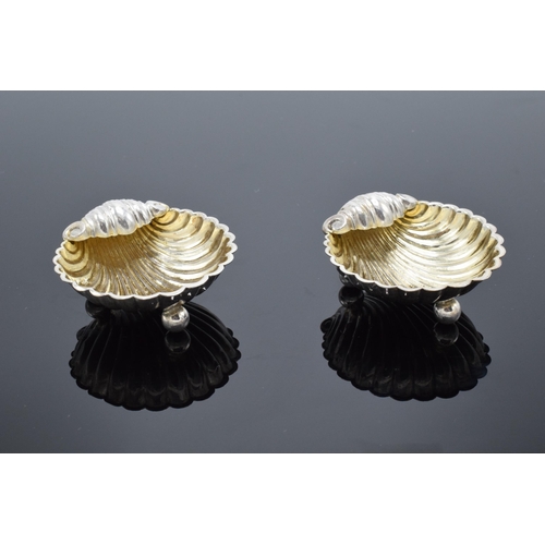 323 - A pair of silver table salts in the form of shells raised on ball feet. Hallmarked for Birmingham ci... 