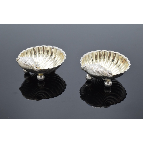 323 - A pair of silver table salts in the form of shells raised on ball feet. Hallmarked for Birmingham ci... 