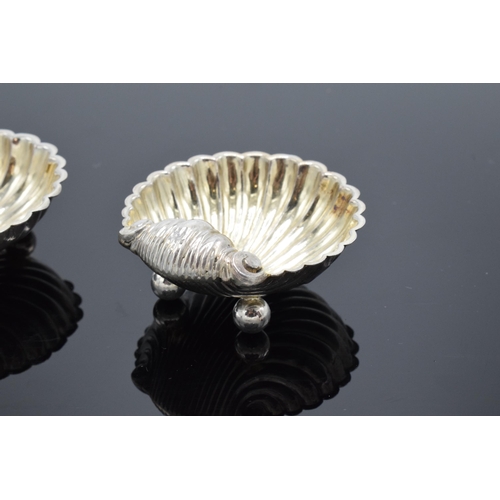 323 - A pair of silver table salts in the form of shells raised on ball feet. Hallmarked for Birmingham ci... 