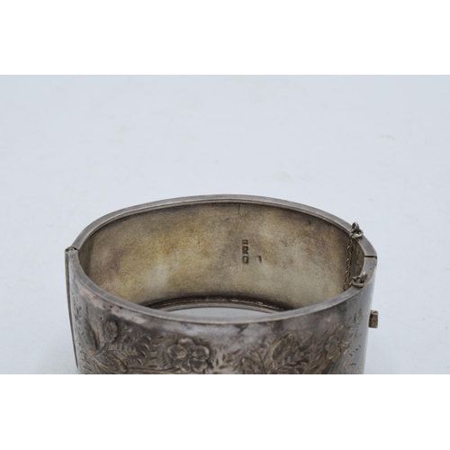 328 - A collection of silver bangles / bracelets with floral decorations. 79.5 grams. In good condition. S... 