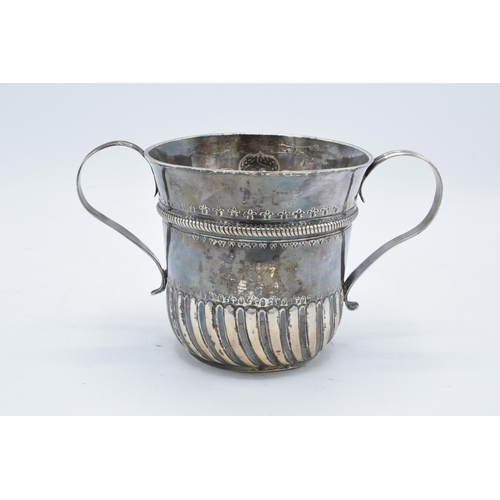 351 - A large silver porringer decorated with an embossed cherub decoration. 339.7 grams. In good conditio... 