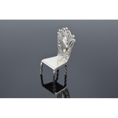 363 - Silver (925) miniature model of a hall chair. 10.8 grams. 5cm tall.