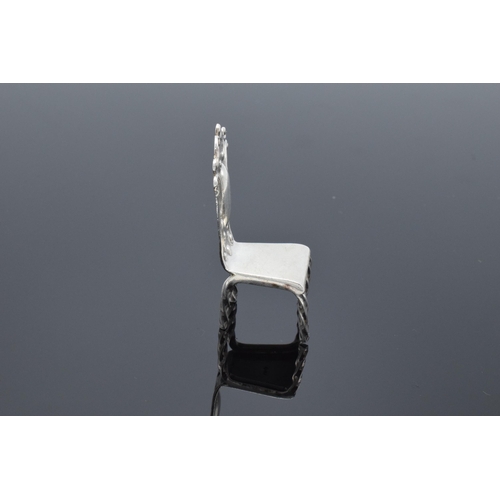 363 - Silver (925) miniature model of a hall chair. 10.8 grams. 5cm tall.