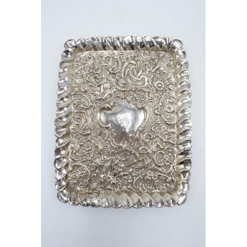 370 - An embossed silver tray with cherubs amongst foliage decoration. Hallmarked for Chester 1900, made b... 