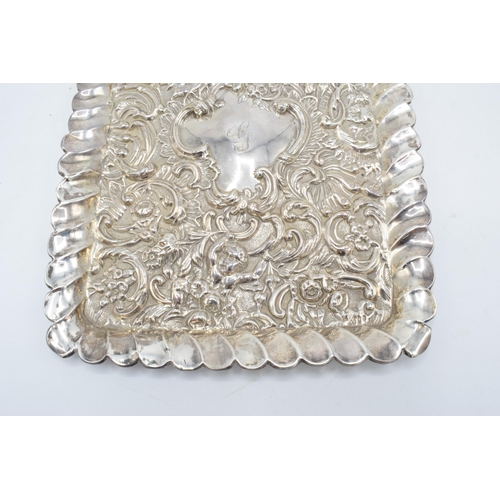 370 - An embossed silver tray with cherubs amongst foliage decoration. Hallmarked for Chester 1900, made b... 