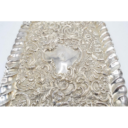 370 - An embossed silver tray with cherubs amongst foliage decoration. Hallmarked for Chester 1900, made b... 