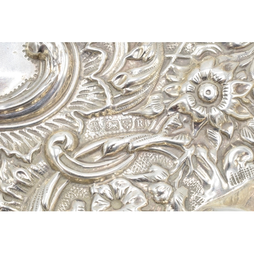 370 - An embossed silver tray with cherubs amongst foliage decoration. Hallmarked for Chester 1900, made b... 