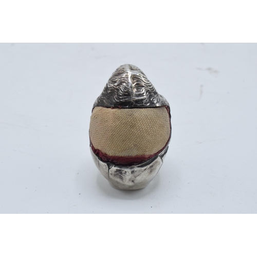 378 - A novelty silver pin cushion modelled as a baby bird hatching from a broken egg shell. Sampson Morda... 