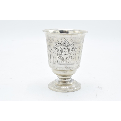 387 - Continental silver footed beaker with engraved decoration. 9cm tall. 63.3 grams.