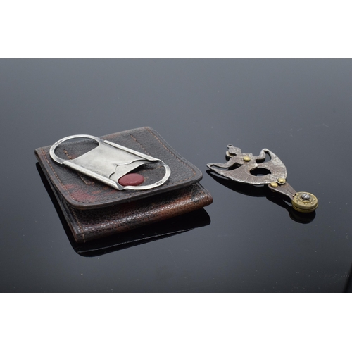 390 - A silver cigar cutter in a leather case (Birmingham 1909) together with a steel example in the form ... 