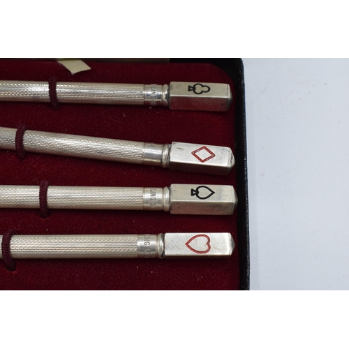 399 - A sterling silver set of 4 bridge pencils with the tops of the pencils depicting the 4 suits. 9cm lo... 