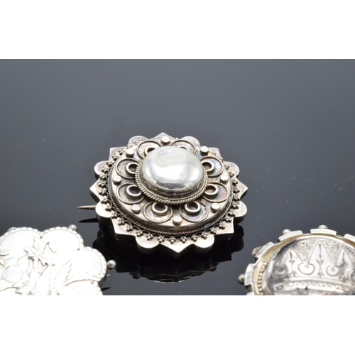 554 - A collection of Victorian silver brooches to include a hallmarked example for Birmingham 1888 (3). 1... 