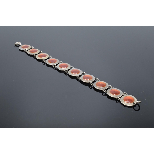 557 - A 20th century sterling silver and red enamel bracelet. 14.5 grams. 19cm long. In good condition gen... 