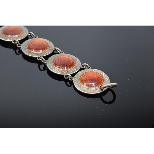 557 - A 20th century sterling silver and red enamel bracelet. 14.5 grams. 19cm long. In good condition gen... 